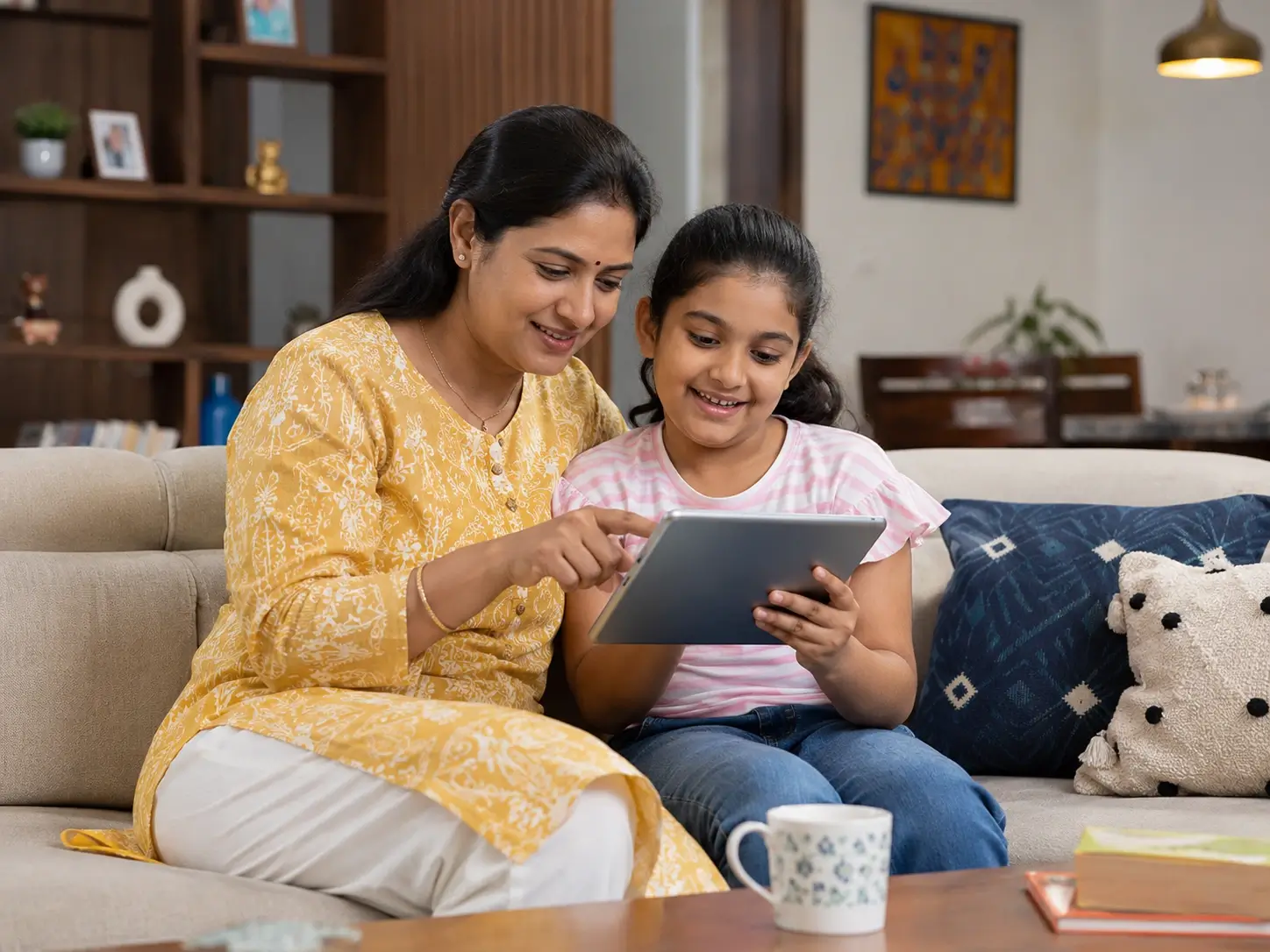 Parent and child navigating a tablet together